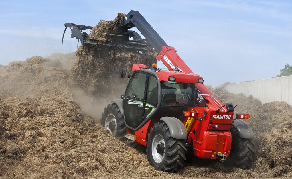 Red Farm Equipment picking up straw
