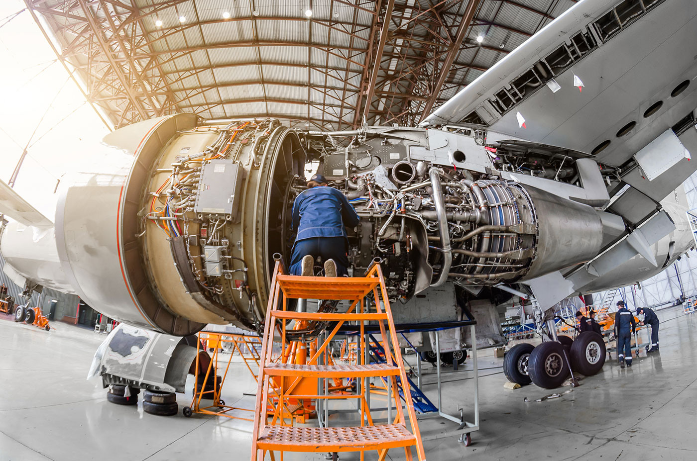 man working on airplane engine