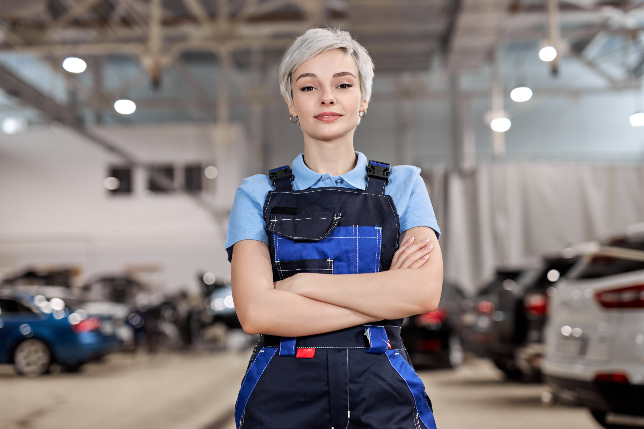 female technician standing in car shop