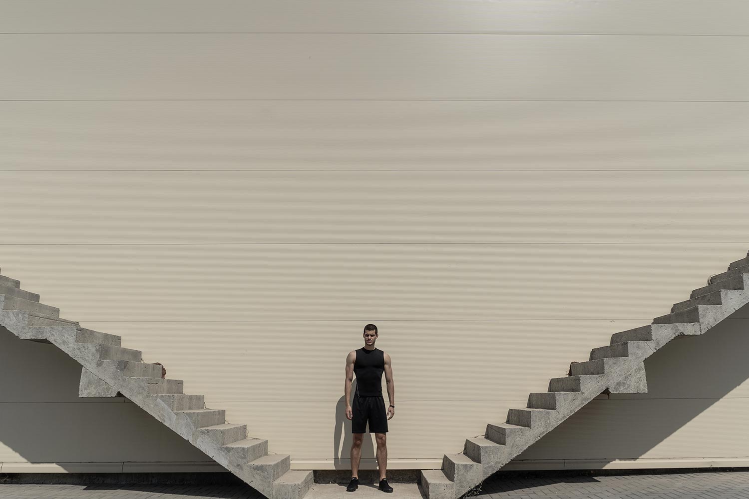 Man standing between stairs