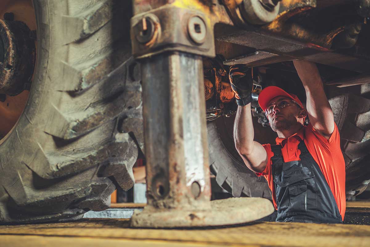 Automotive technician working under a vehicle