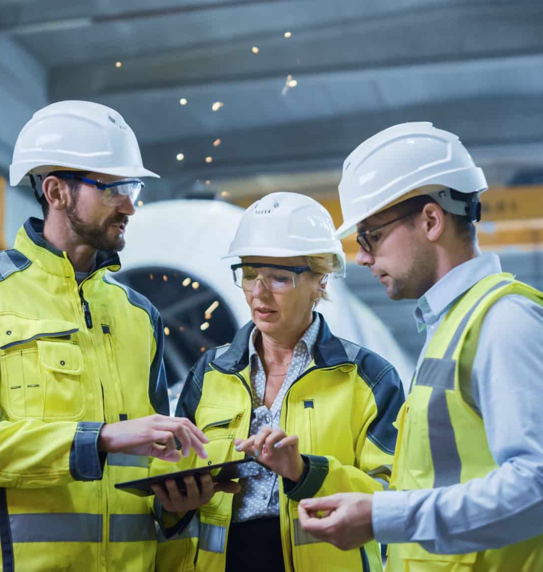 Three technicians / engineers discussing over a tablet