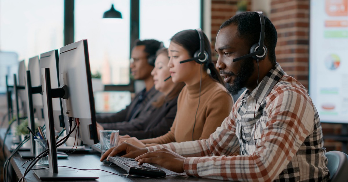 A customer support team sitting at computers