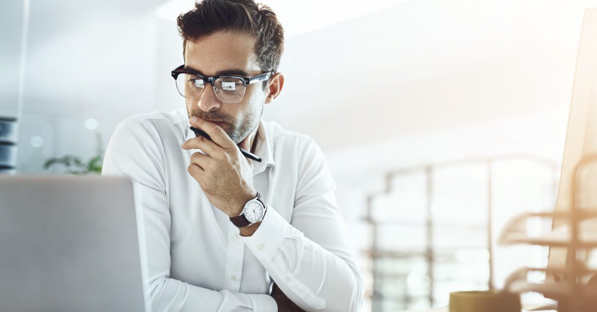 Computer, thinking and business man in office, working on project or email. Laptop, professional and male person problem solving, looking for solution or planning, reading or focus on decision making.